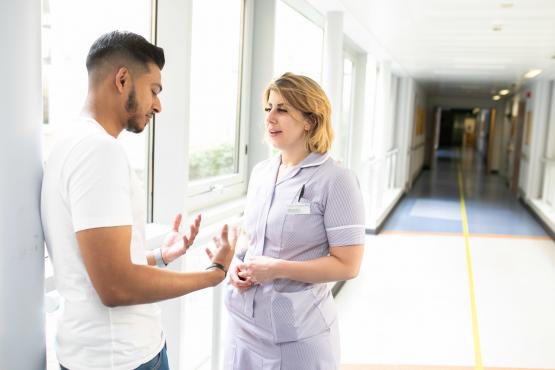 Man talking to a nurse Man talking to a nurse