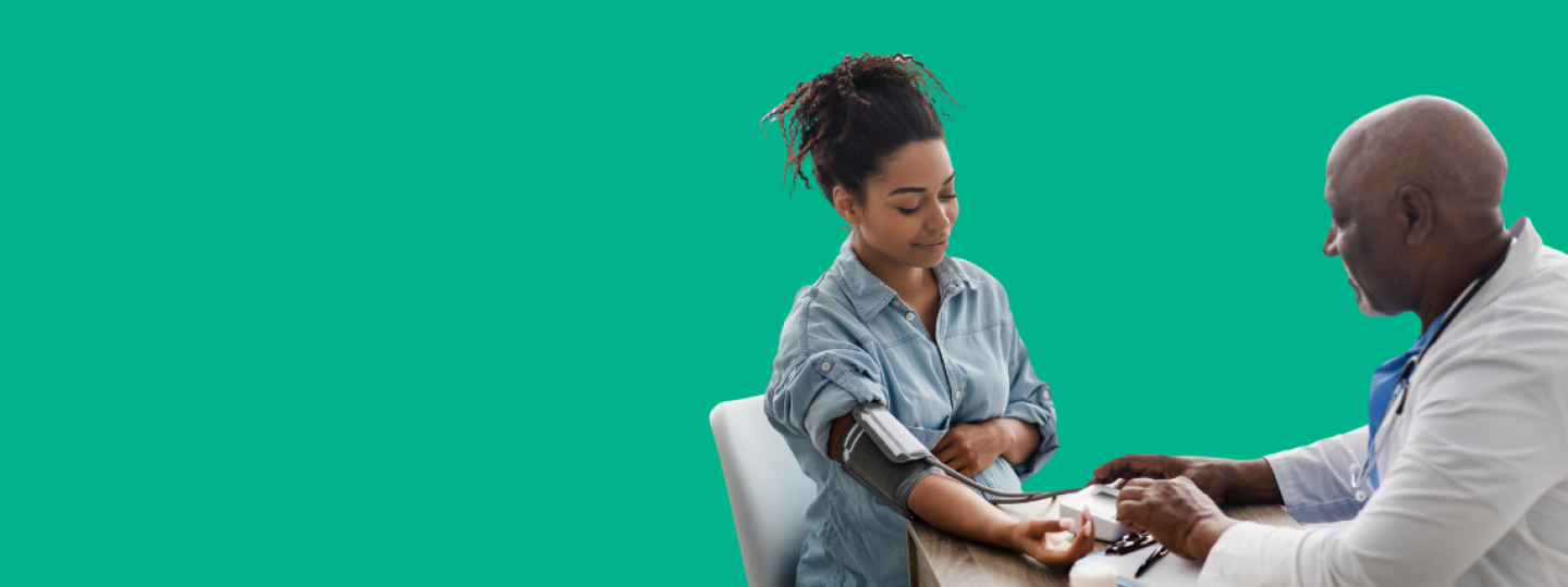 A doctor taking the blood pressure of a patient.