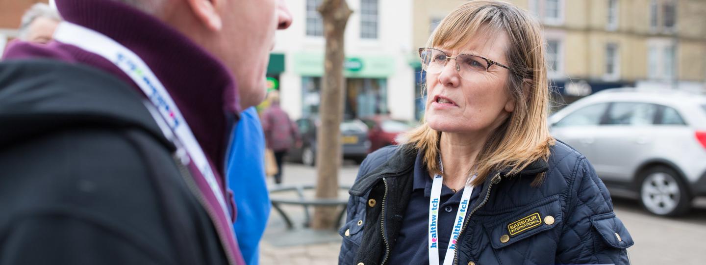 Healthwatch staff member talking to a member of the public about their experience