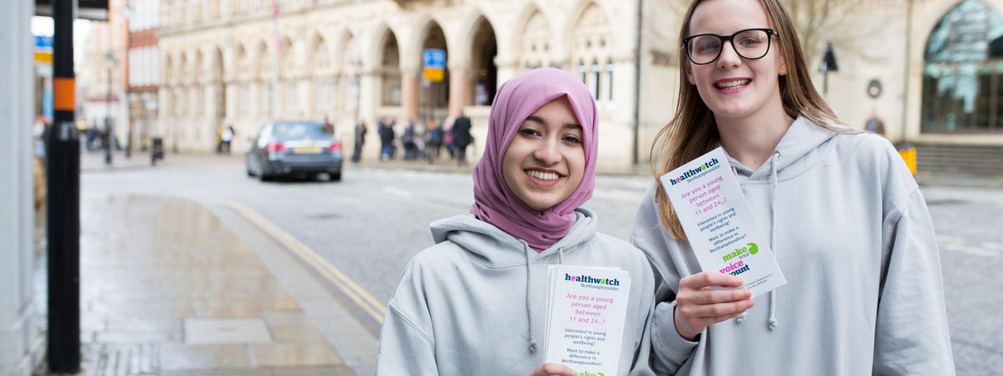 Two young female volunteers promoting Healthwatch