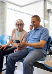 Husband and wife sat in a hospital waiting area