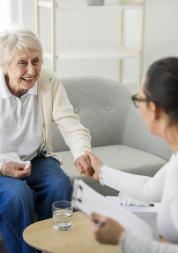 Old woman talking with a healthcare professional in a GP practice